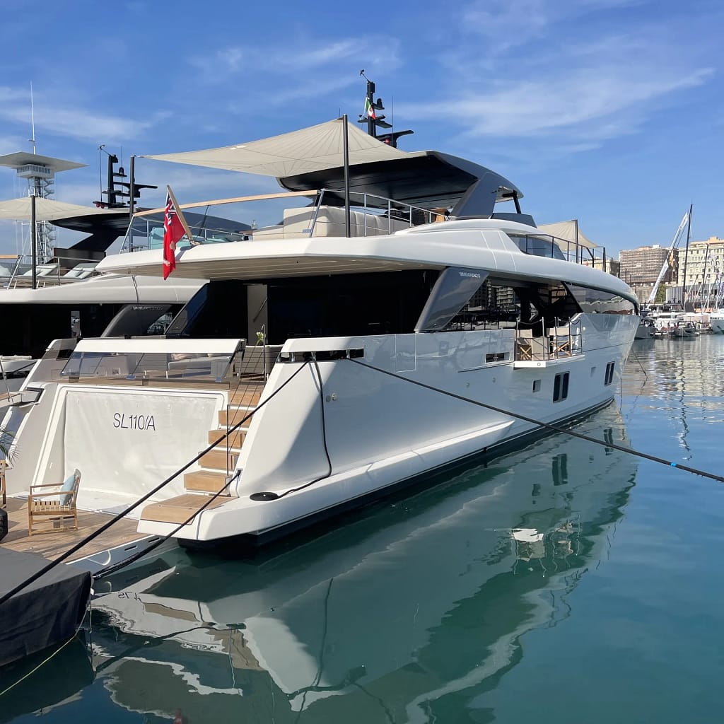 Luxury Yacht Charter for UHNW Clients 12 White motor yacht with a flybridge moored at the quay, a typical vessel for luxury yacht charter