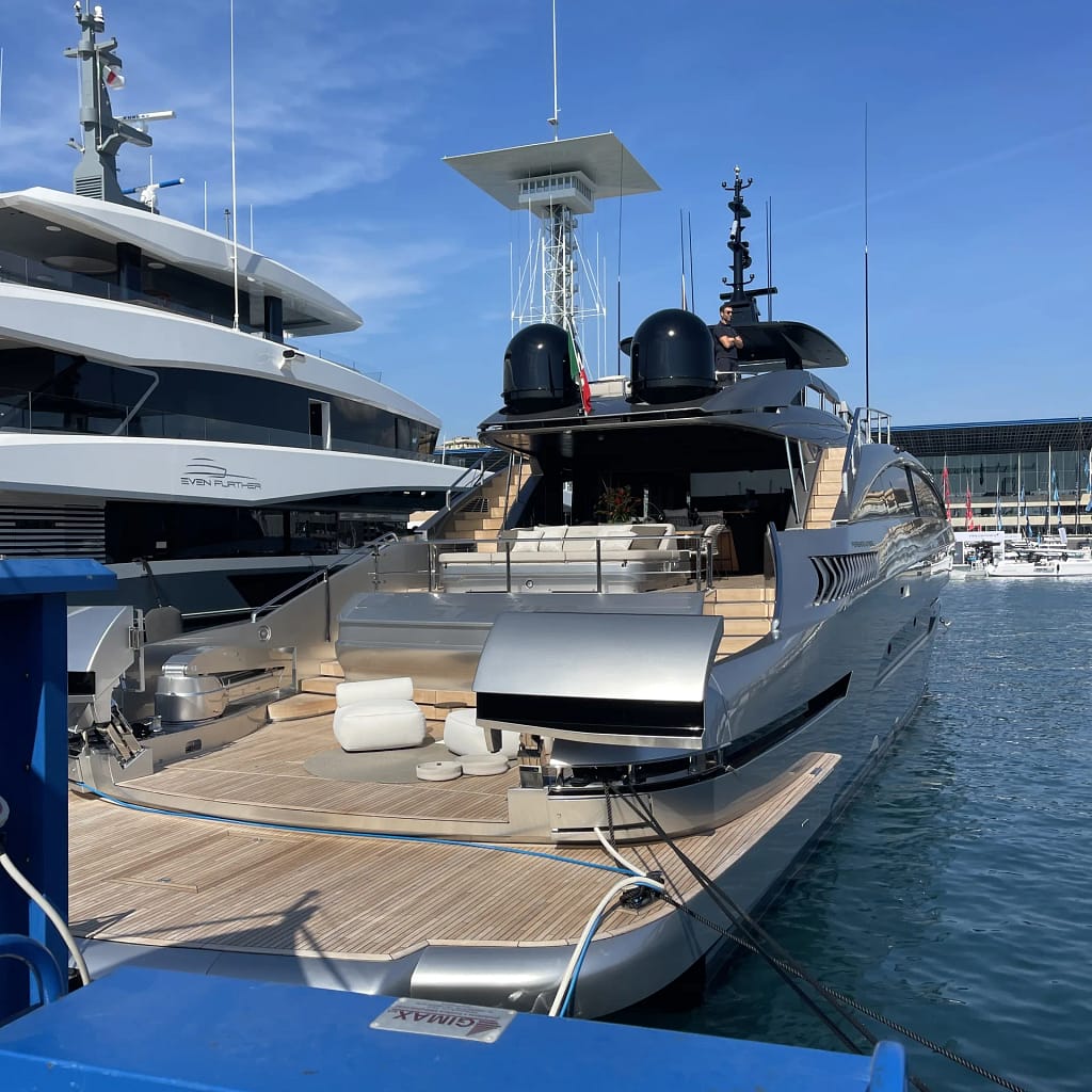 Stern of a motor yacht with teak deck, seen from the quay
