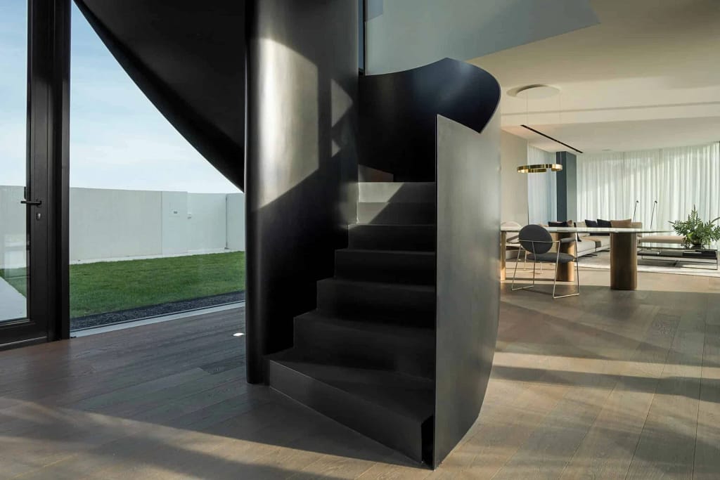 Luxury Furniture for Villas 18 Black steel spiral staircase of the AV Home villa, a project by Federico Cappellina's studio