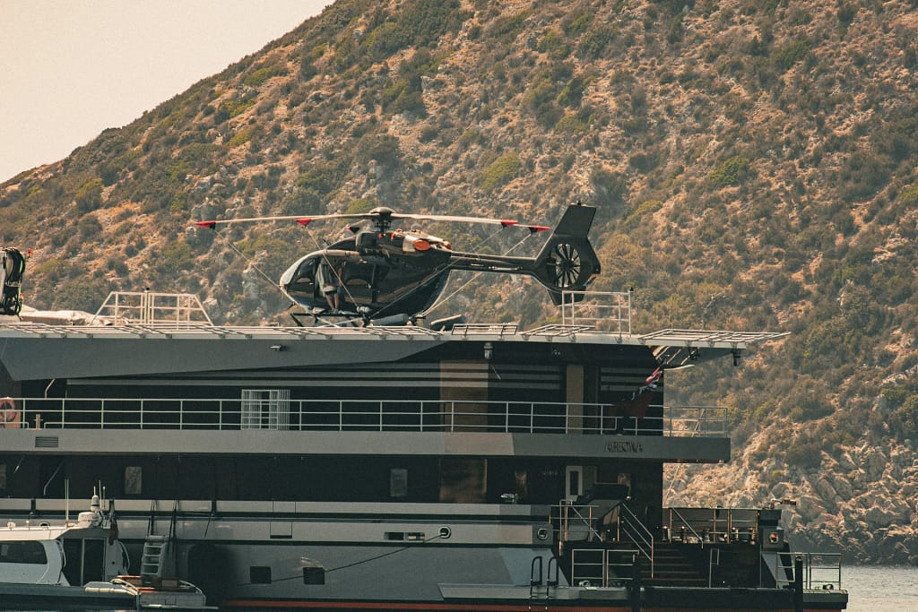 Private Jet Charter for UHNW Clients 6 Helicopter on the helipad of a superyacht, a private transfer linking air and sea