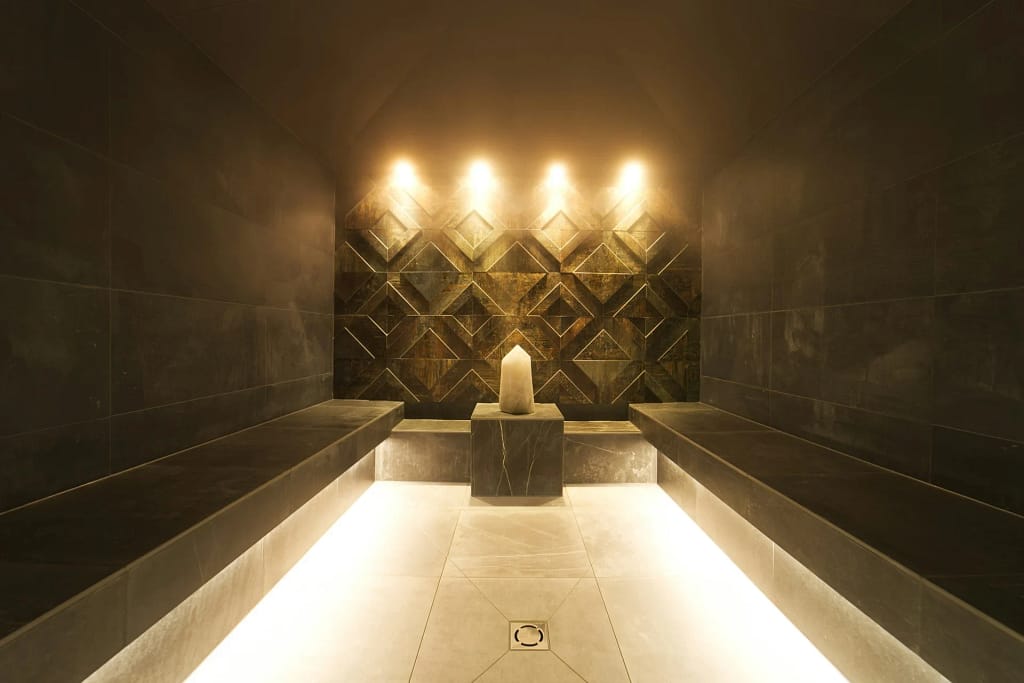 Home Spa: Sauna, Steam, Water and Rest 3 Home spa: stone Turkish bath with warm light and seating (illustrative photo)
