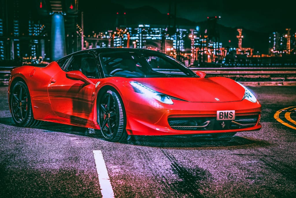 Private Villa Events and Concierge 3 Private villa events: red Ferrari in the city at night (illustrative photo)