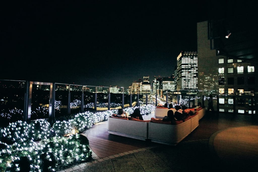 Private Villa Events and Concierge 18 Private villa events: rooftop party overlooking skyscrapers at night (illustrative photo)
