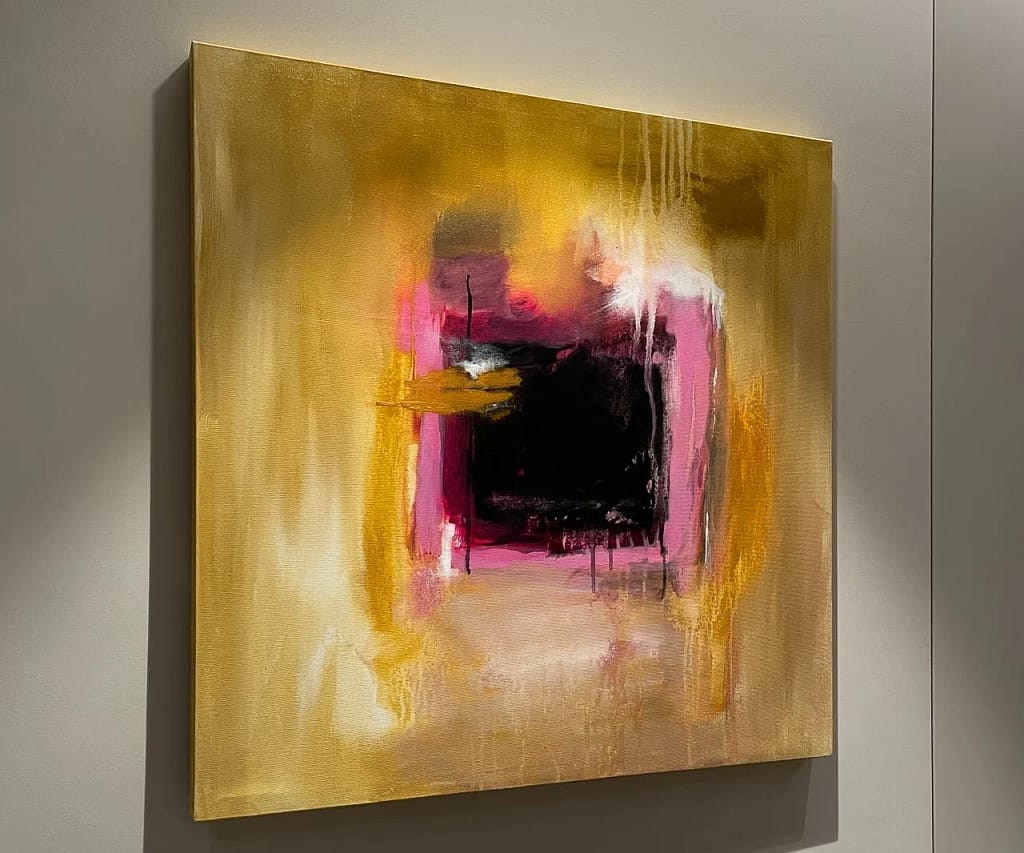 Art and design objects: abstract painting in gold, pink and black lit on a white wall, a project by Federico Cappellina's studio