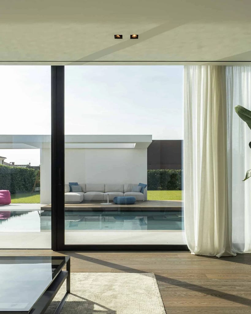 Luxury Windows — Glazing and Doors 15 Luxury windows: living room with large sliding glazing towards the pool