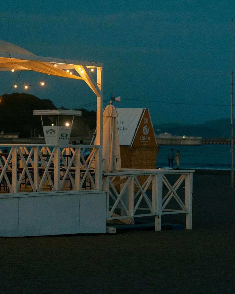 Private Villa Events and Concierge 20 Private villa events: beach club with pergola and lights by the sea at night (illustrative photo)